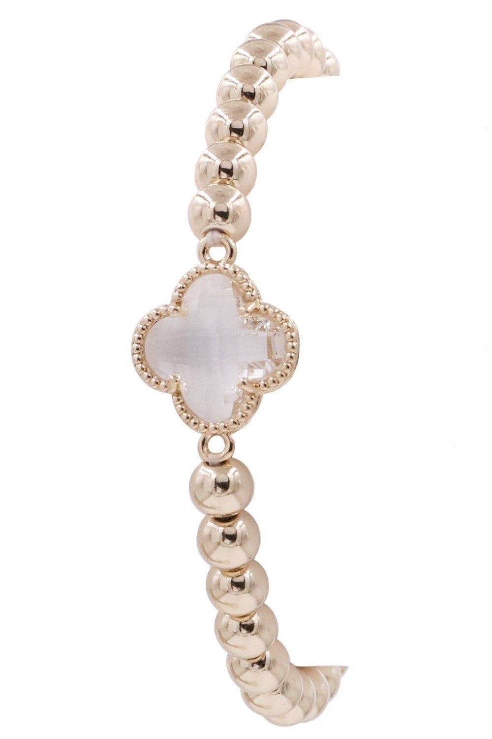 Gold beaded bracelet with a polished finish, central crystal clover charm, and white stone. Available in S, M, L.