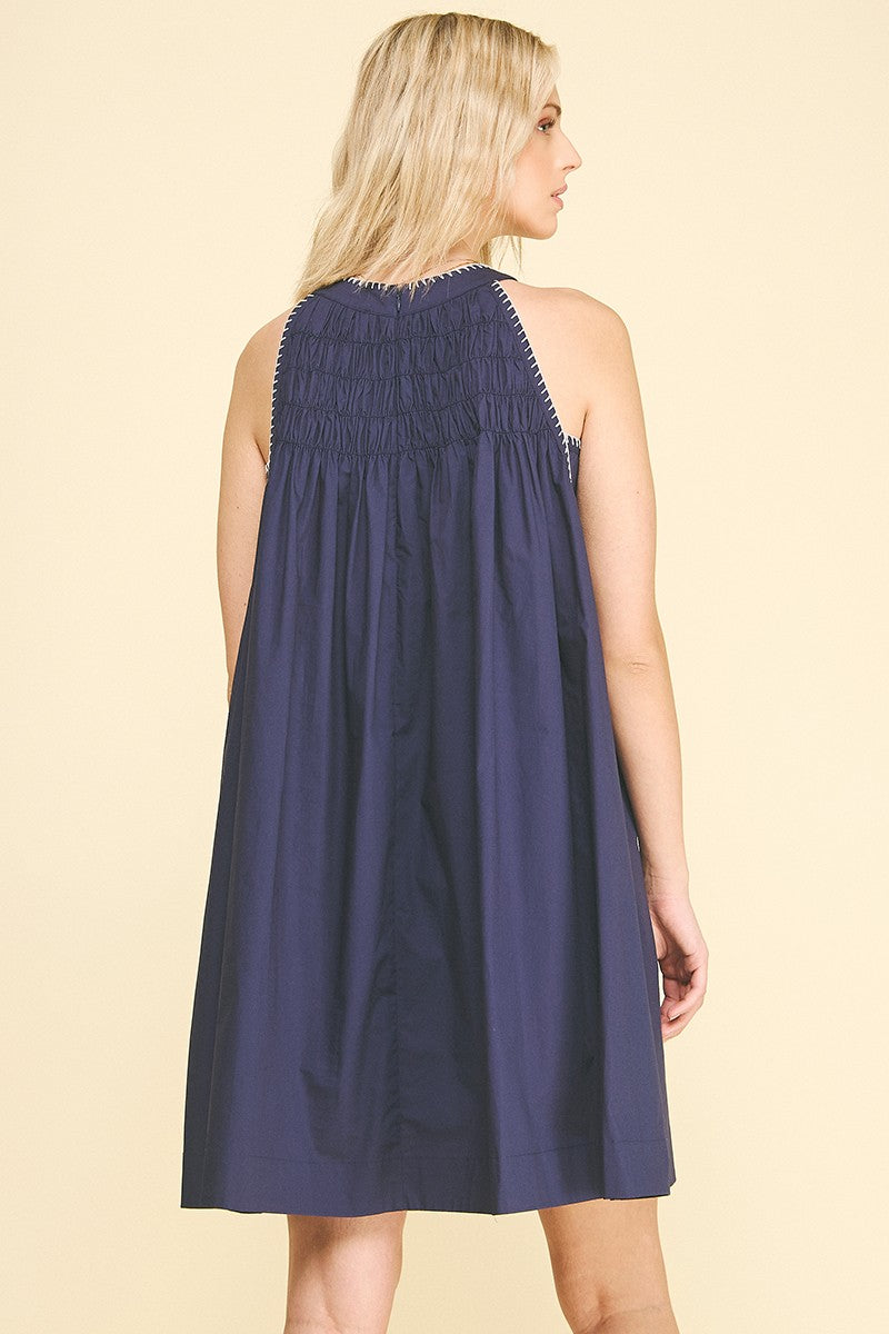Navy Halter Neck A-line Dress with sleeveless design and shirred smocked upper back. Available in sizes XS-XL.