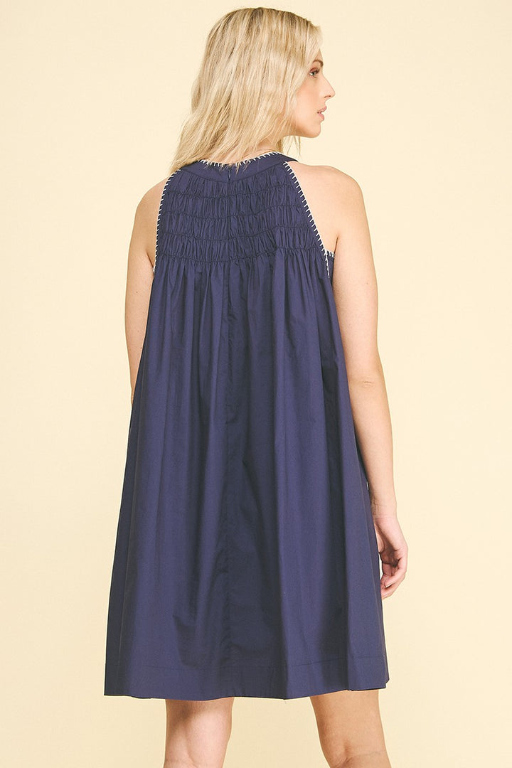 Navy Halter Neck A-line Dress with sleeveless design and shirred smocked upper back. Available in sizes XS-XL.