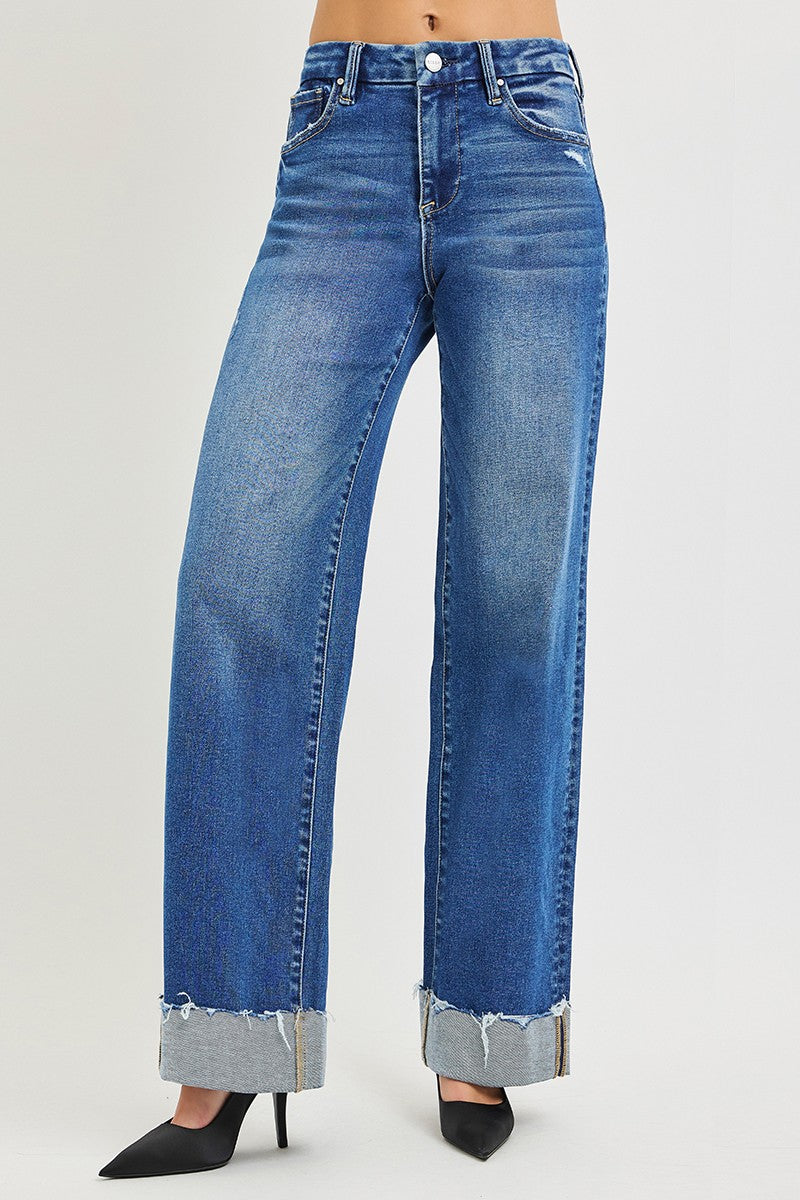 Risen High Rise Wide Leg Jeans with cuffed, frayed hems, faded wash, five-pocket design. Sizes: 24–32.