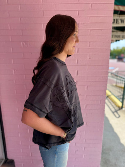 Dark oversized Dye & Wash Gameday Terry Top in soft French terry fabric; available in sizes XS-XL.