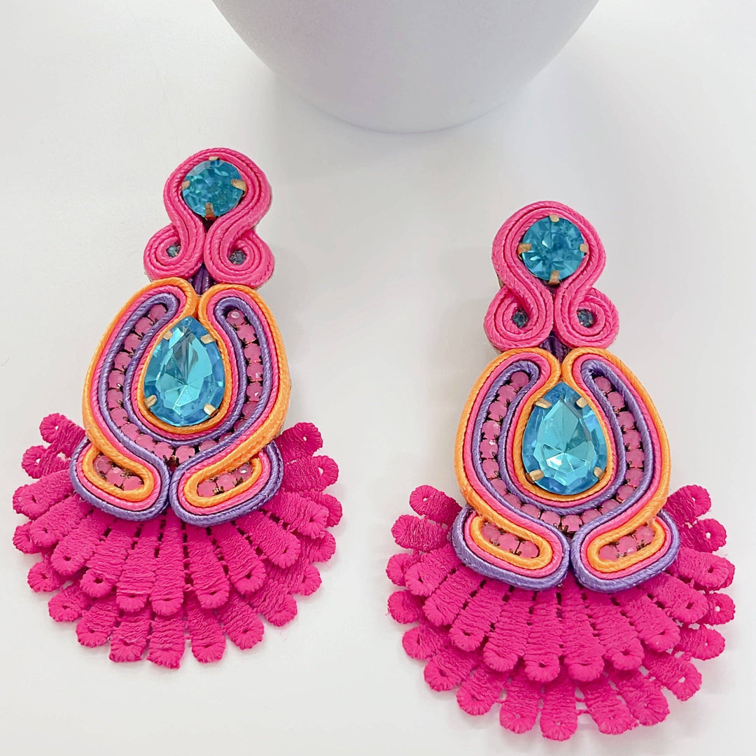 The Sammy Pink Earrings: handmade beaded, pink/yellow/orange threadwork, blue gem center, fringed pink edges. Sizes: S, M, L.