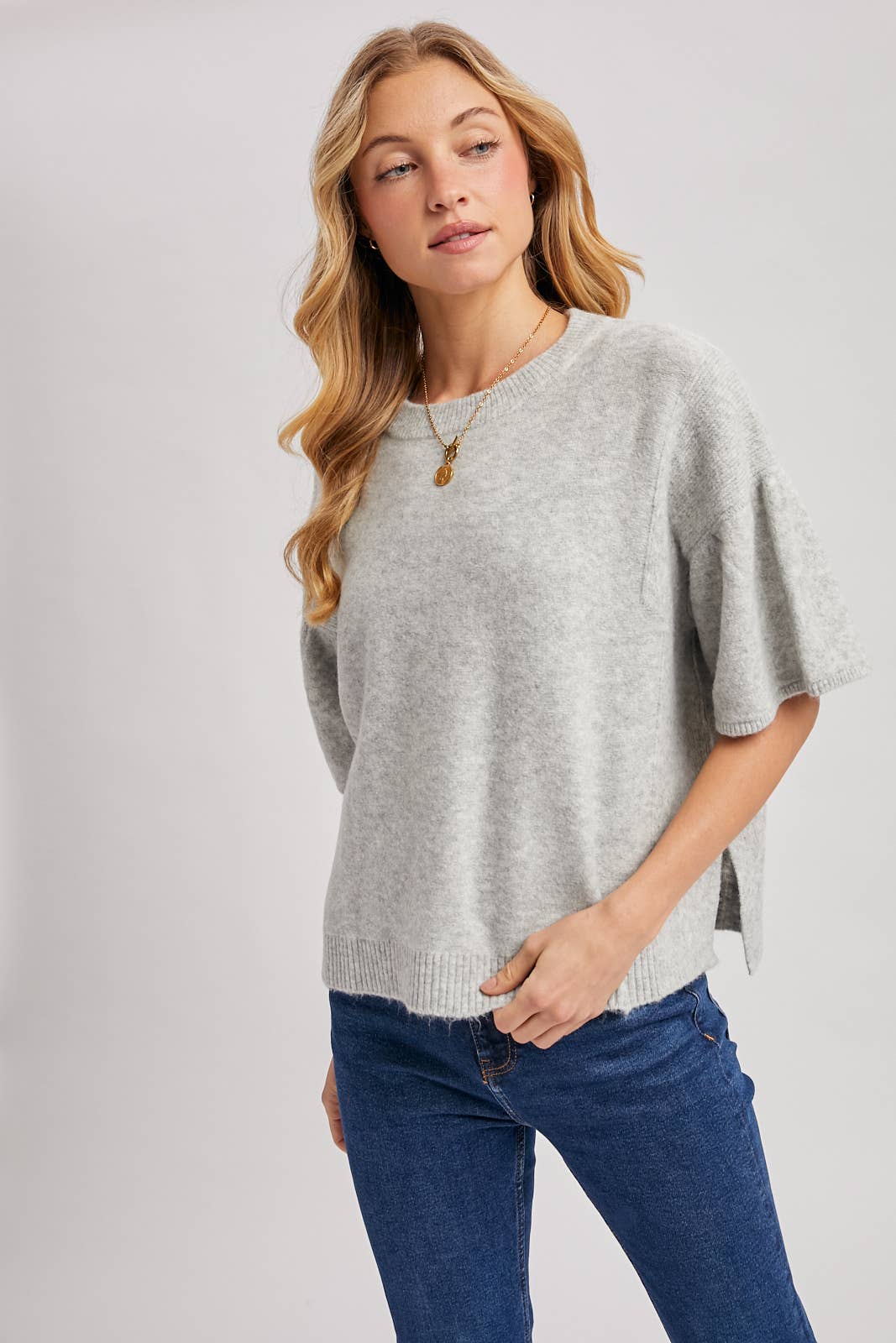 Light gray boxy knit sweater top with gathered short sleeves and side slit. Size: M/L.