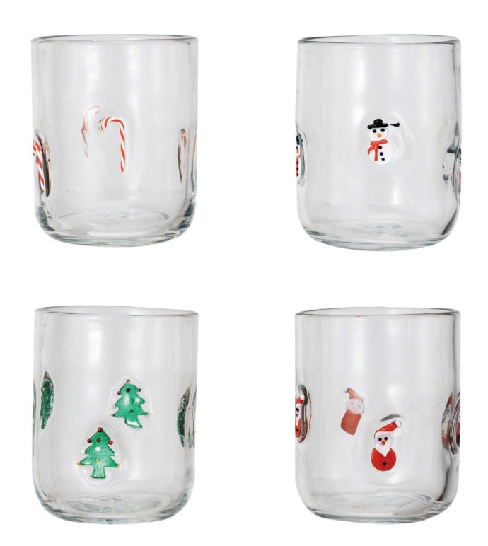Four clear Holiday Icon glasses featuring raised candy cane, snowman, Christmas tree, and Santa Claus designs.