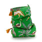 Hand Block Printed Pouches: Set of three stacked green quilted cosmetic bags with wildlife and foliage illustrations, including leopards and birds. Adorned with orange tassels on zipper pulls. Water-resistant design. Sizes: Small, Medium, Large.