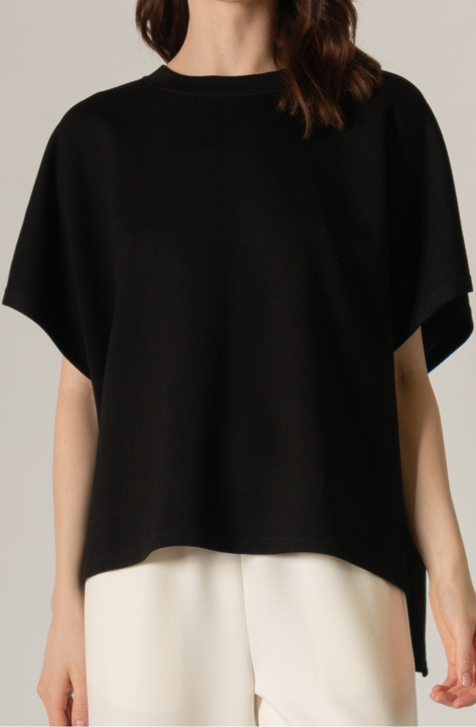 Loose-fitting Butter Modal Side Slit Cape Top, short sleeves, high-low design. Color: Black. Available sizes: XS, S, M, L, XL.