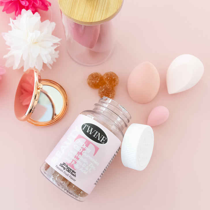 Open bottle of Beauty Gummies with spilled gummies. Available sizes: 60-count, 120-count.