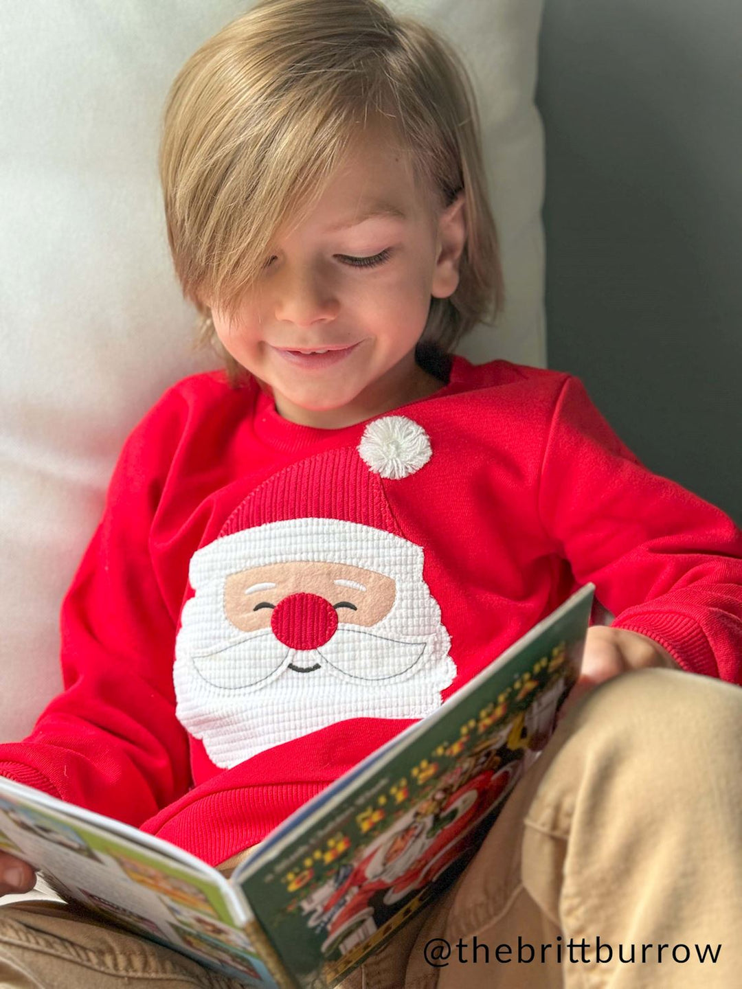 Red Happy Santa sweater with textured face appliqué, pom-pom detail, and long sleeves. Available in all sizes.