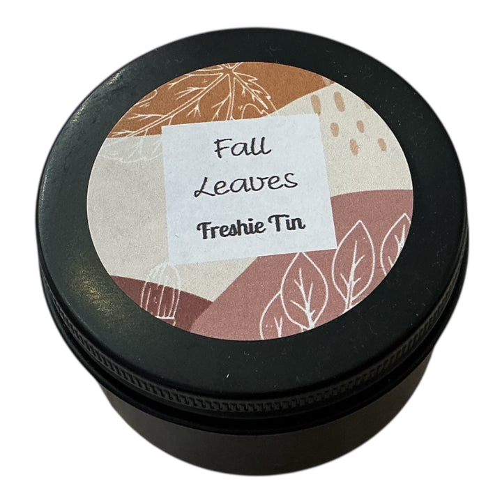 Round black Freshie Tin car air freshener and odor eliminator, available in multiple sizes.