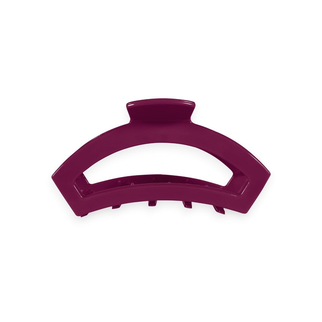Geometric, arc-shaped hair clip in berry purple with short teeth along the bottom; available in size small.