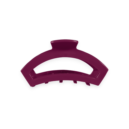 Geometric, arc-shaped hair clip in berry purple with short teeth along the bottom; available in size small.