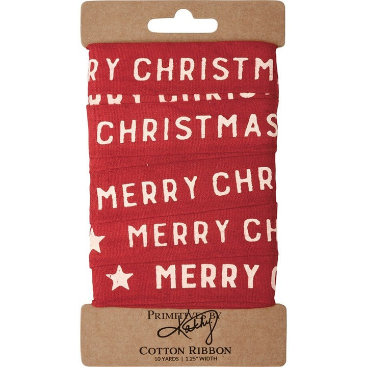 Red Christmas ribbon with white “MERRY CHRISTMAS” text and stars on a cardboard display card.