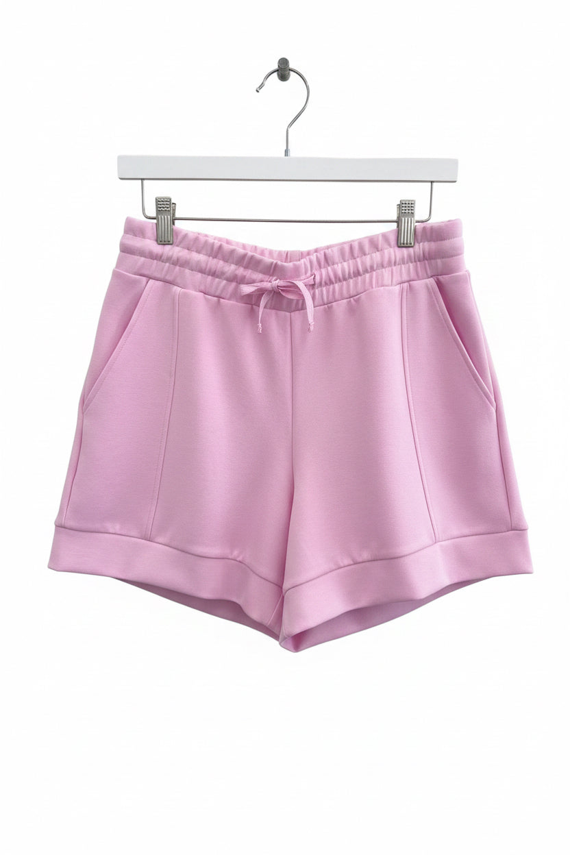 Buttery Soft Shorts in light pink with drawstring, elastic waistband, lightweight fabric, and side pockets. Sizes available: S, M, L, XL.