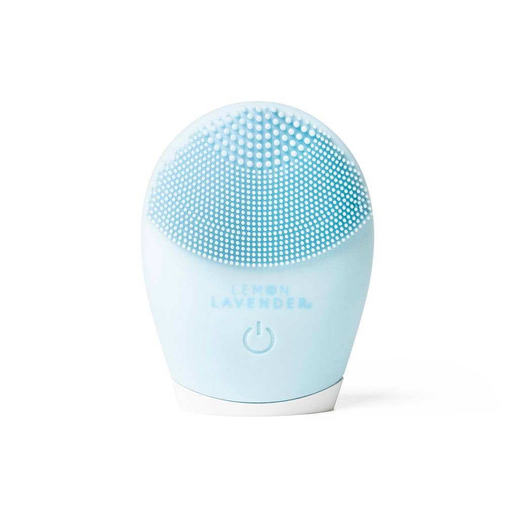 Lemon Lavender It's a Vibe Sonic Cleanser Brush with blue silicone bristles, power button, branding; available in multiple sizes.