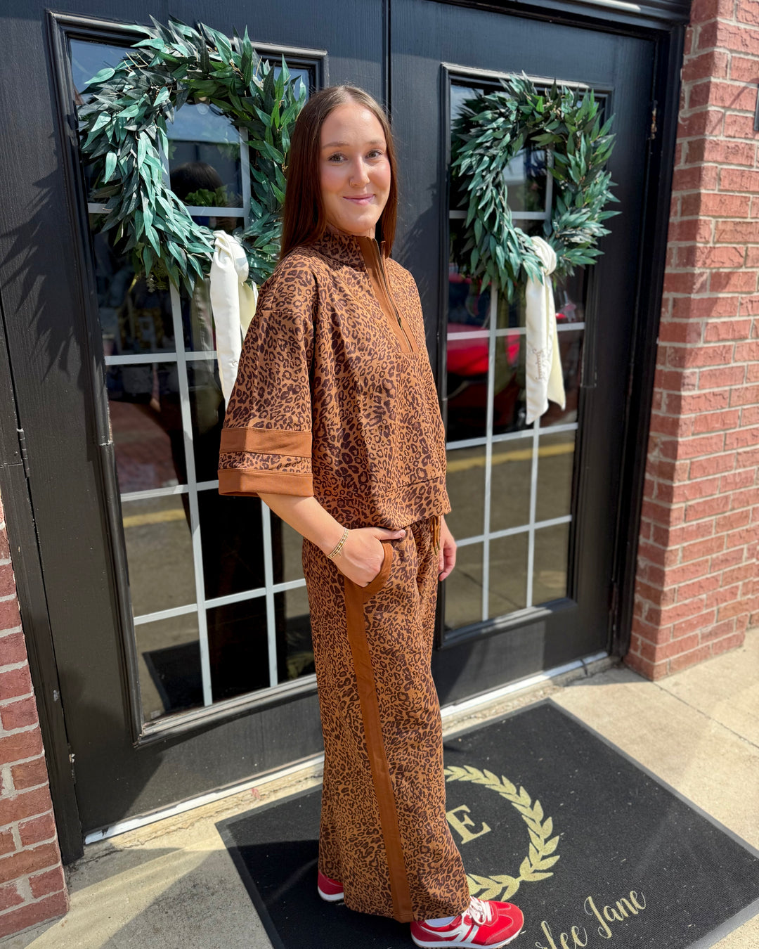 Brown leopard-print zip-up top available in sizes XS–XL.