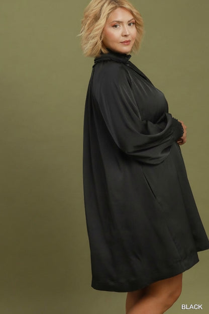 Satin Tie Neck Dress: loose black long-sleeve mini dress with high neckline, subtle ruffle details, and balloon sleeves. Available in plus sizes.