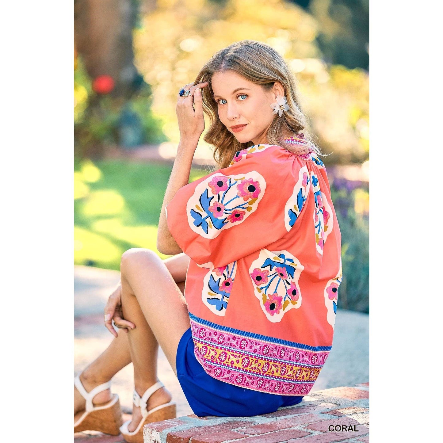 Sunset Floral Embroidery Top shown; available in sizes XS-XL.