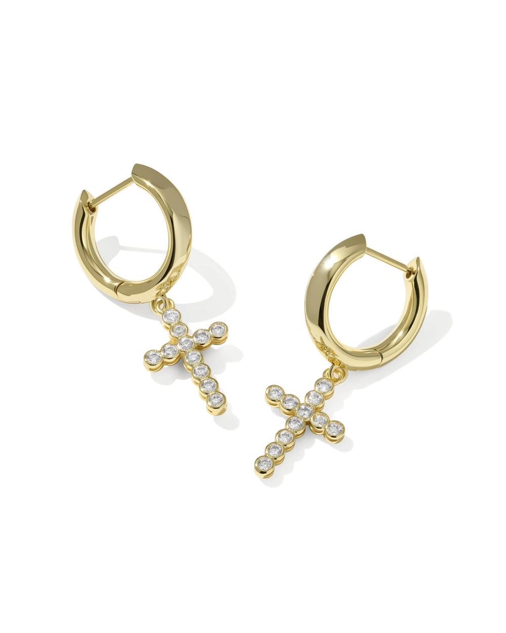 Gold huggie earrings with dangling cross charms, detailed with small clear crystals. Available in S, M, and L sizes.