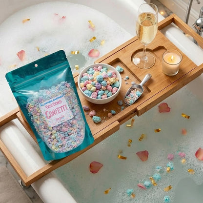 Bath Bomb Confetti in a bowl with a scoop on bathtub tray. Available in small, medium, and large sizes.