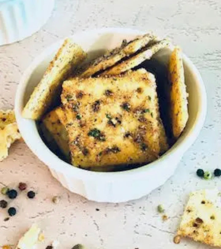 Square crackers in a white bowl, Chipotle Barbeque flavor. Available in 6 oz and 12 oz sizes.