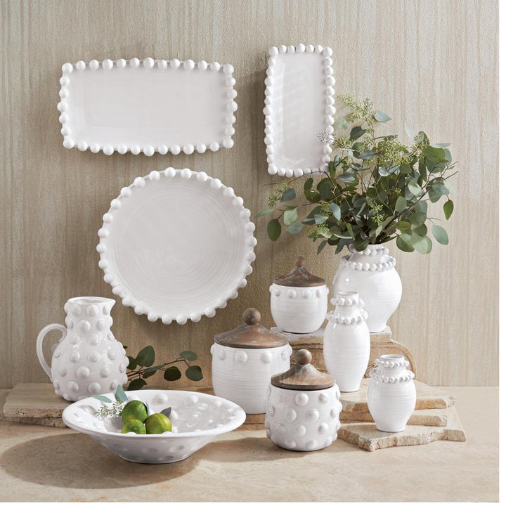 The Raised Dot Platter is a white ceramic dish with raised dot designs. Available in small, medium, and large sizes.