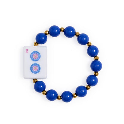 Mahjong Beaded Stretch Bracelet with round blue beads, small gold accents, and a white tile featuring two blue circles and a pink number 2. Available in multiple sizes.