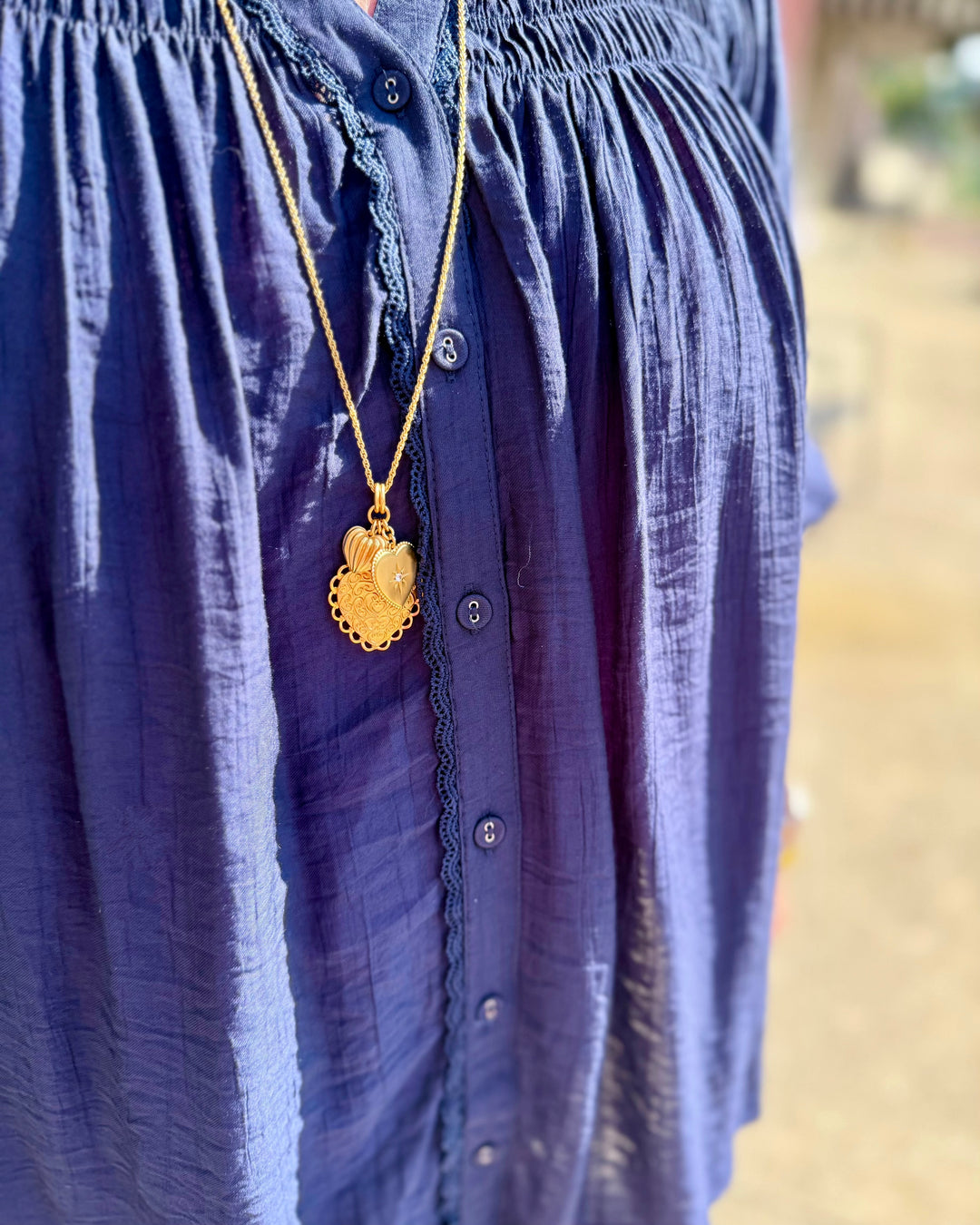 Navy Smocked Yoke Button Front Blouse with textured fabric and button front details, available in sizes XS-XL.