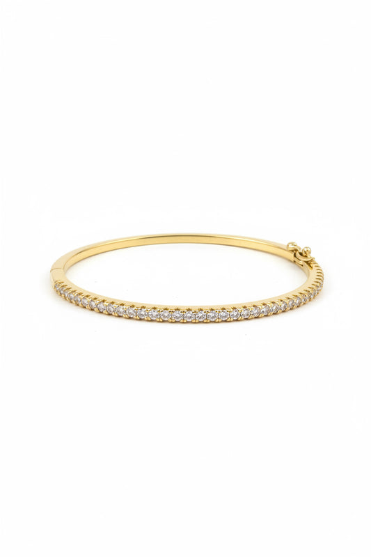 Gold-finished hinged bangle with a single row of sparkling CZ stones. Available in multiple sizes. Ideal for stacking.