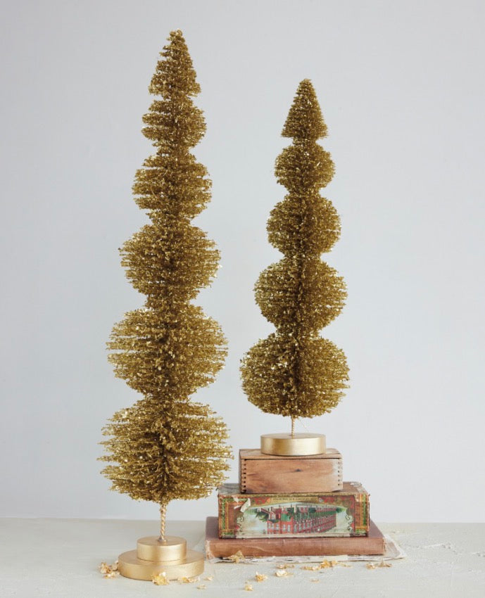 Two gold glitter bottle brush topiary trees on paulownia wood bases, in two heights.