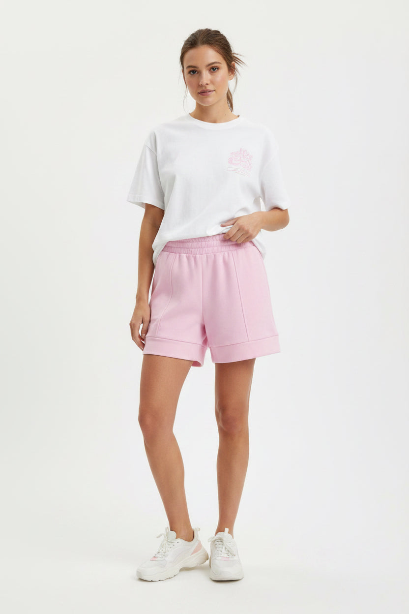Buttery Soft Shorts in light pink with an elastic waistband and lightweight fabric. Available in sizes XS–XL.