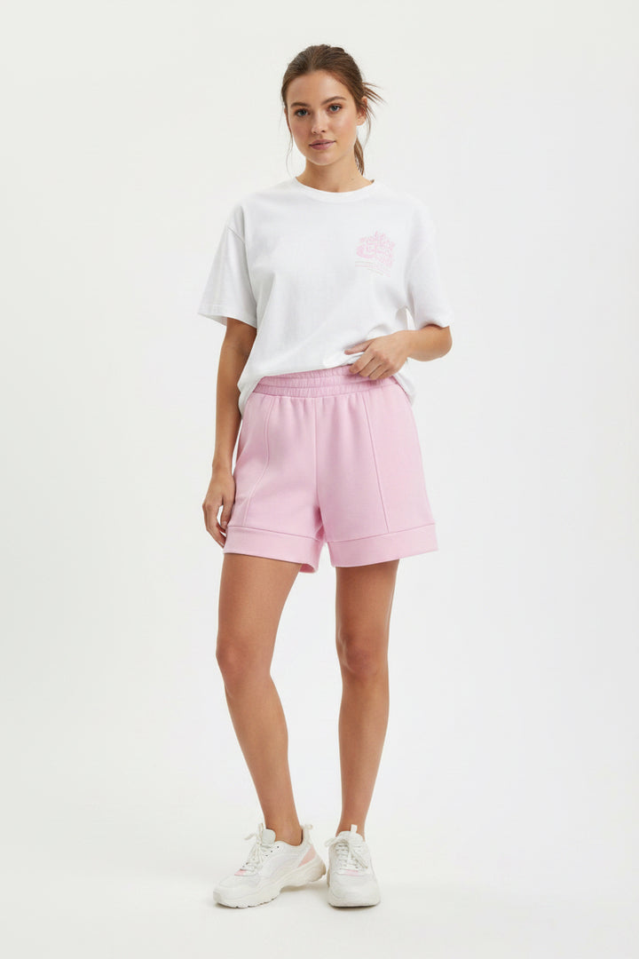 Buttery Soft Shorts in light pink with an elastic waistband and lightweight fabric. Available in sizes XS–XL.