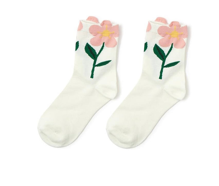 White cotton socks with pink flowers, yellow centers, and green stems at the ankles. Available in sizes S, M, L.