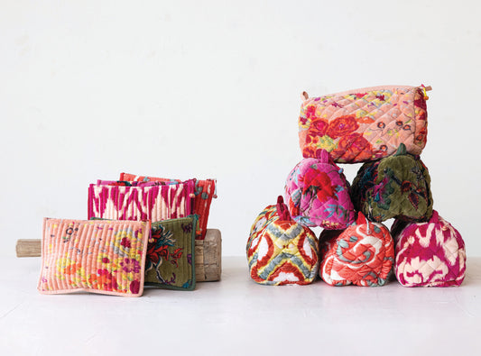 Quilted cotton velvet printed zip pouches in colorful patterns, available in small, medium, and large sizes.