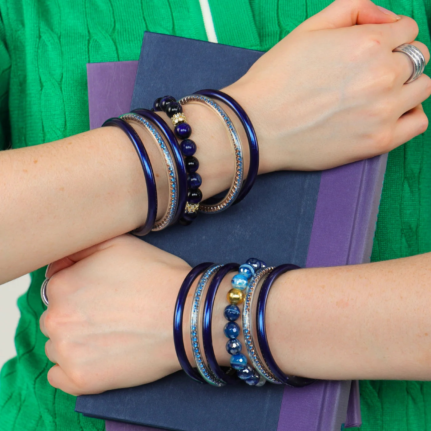 Midnight All Weather Bangles, including a waterproof bangle, shown stacked on wrist; available in small, medium, and large sizes.
