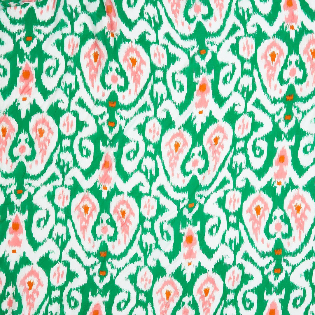 Green short kimono with vibrant Ikat pattern in green, white, and peach. Available in sizes S, M, L.