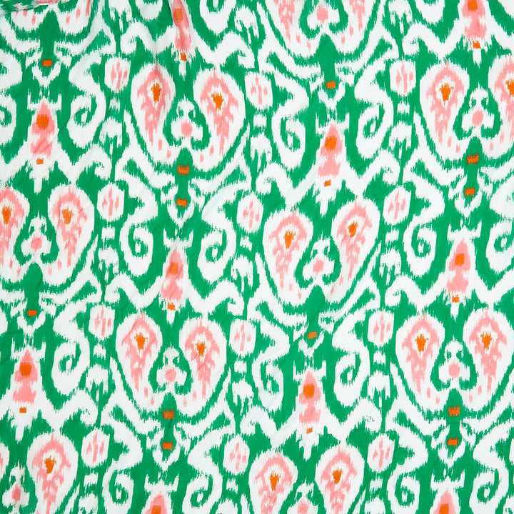 Green short kimono with vibrant Ikat pattern in green, white, and peach. Available in sizes S, M, L.