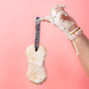 Sweet Grace Body Wash Sponge with loop, covered in rich suds. Available in standard and travel sizes.
