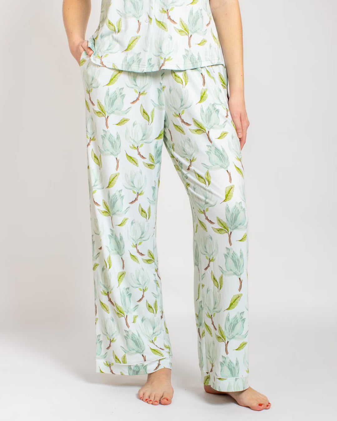 Audrey Pajamas bottoms in white with green and light blue Magnolia floral print. Available in sizes XS–XL.