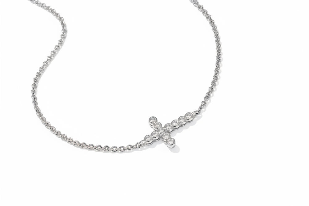 The Cross Crystal Delicate Bracelet has a sideways cross pendant with round clear crystals; available in multiple sizes.