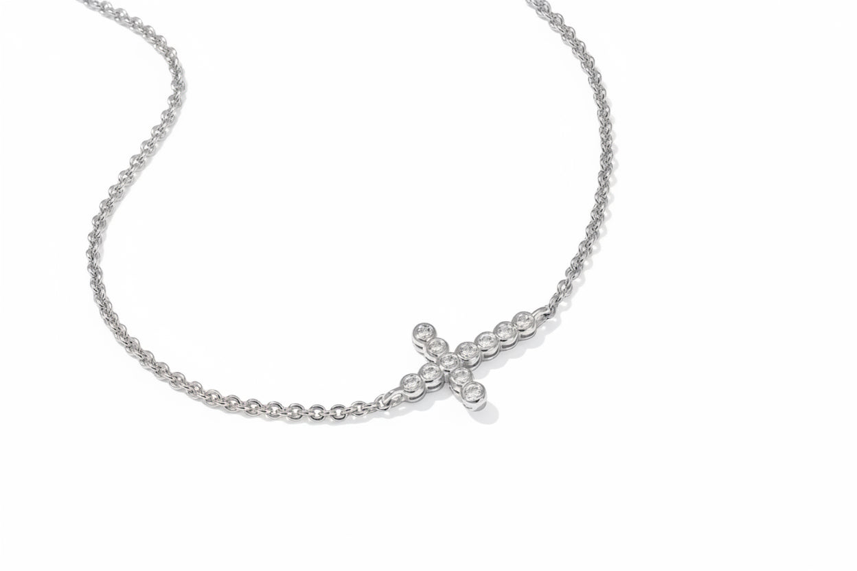 The Cross Crystal Delicate Bracelet has a sideways cross pendant with round clear crystals; available in multiple sizes.