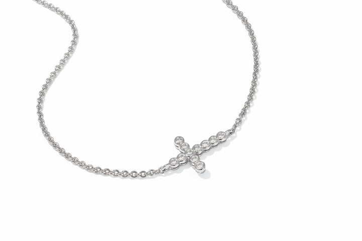 The Cross Crystal Delicate Bracelet has a sideways cross pendant with round clear crystals; available in multiple sizes.
