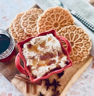 Carmie’s Pumpkin Spice Cheesecake Dip Mix in a red bowl, topped with cinnamon sticks and star anise. Available in 8 oz and 16 oz sizes.