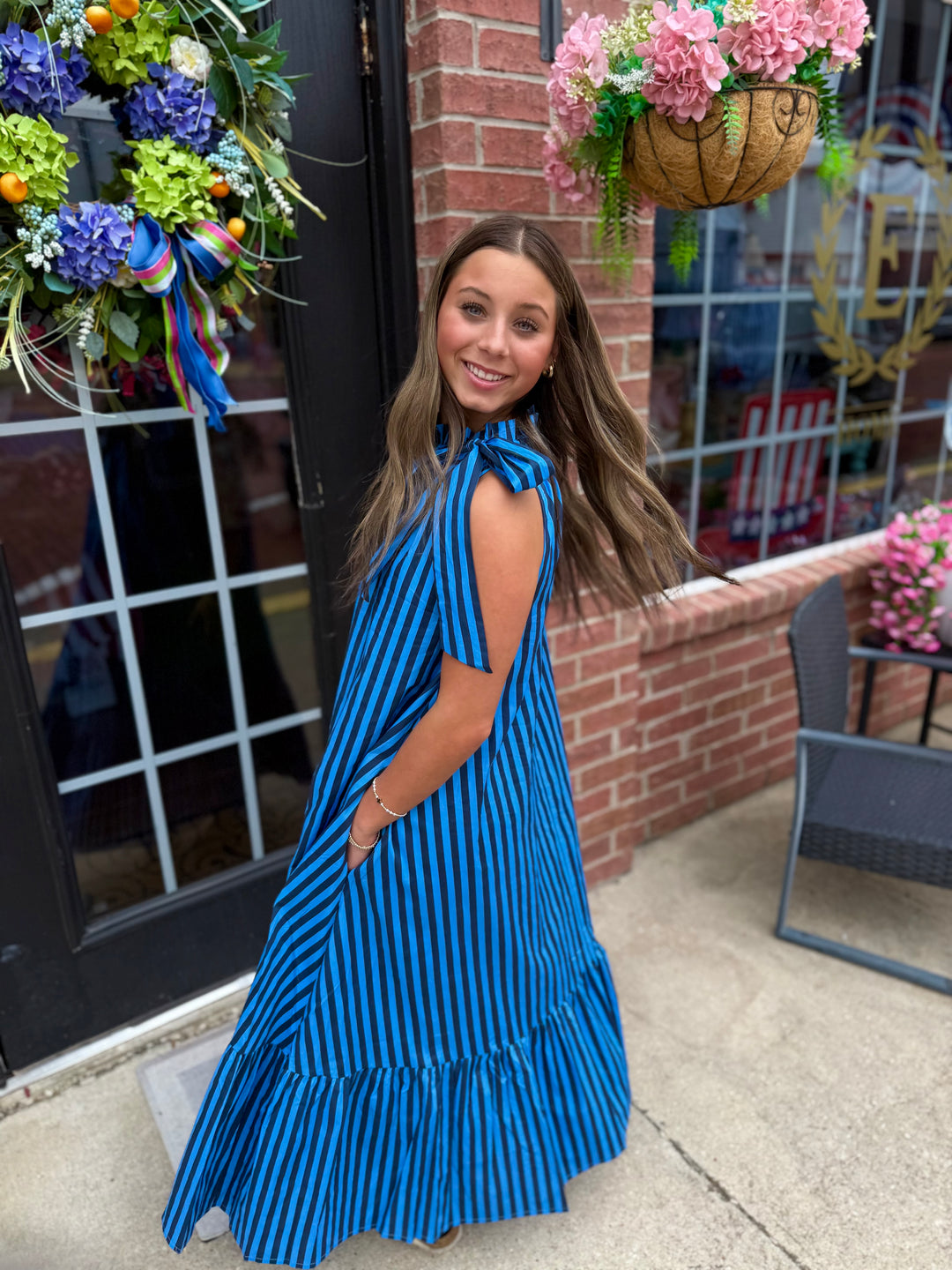 Navy Stripe Tie-Neck Midi Dress with tie-neck detail and stripe pattern. Available in sizes XS-XL.