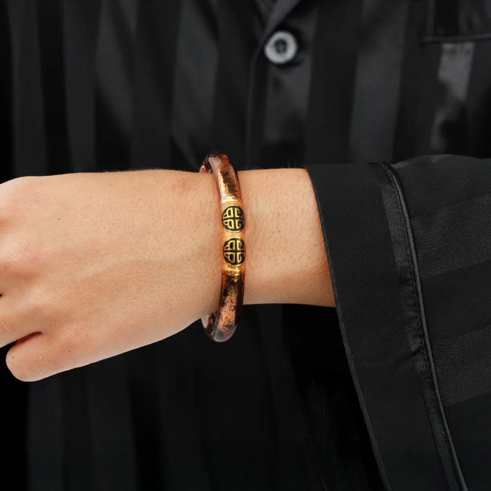 Handcrafted KOI Leopard Tzubbie All Weather Bangle with two gold decorative beads engraved with an intricate pattern; available in S, M, and L sizes.