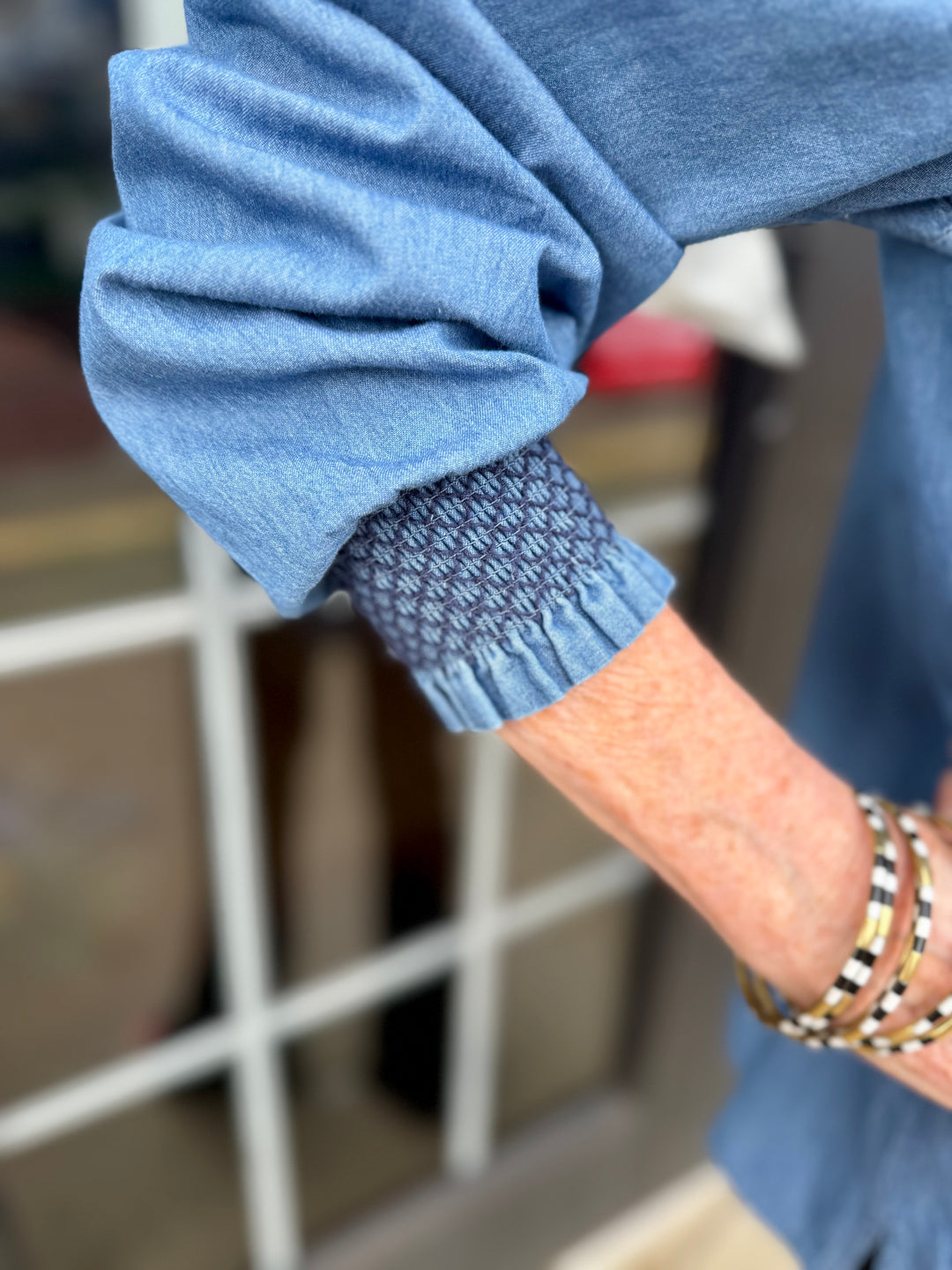 Kimberly Chambray Top with patterned cuff, available in sizes XS–XL.