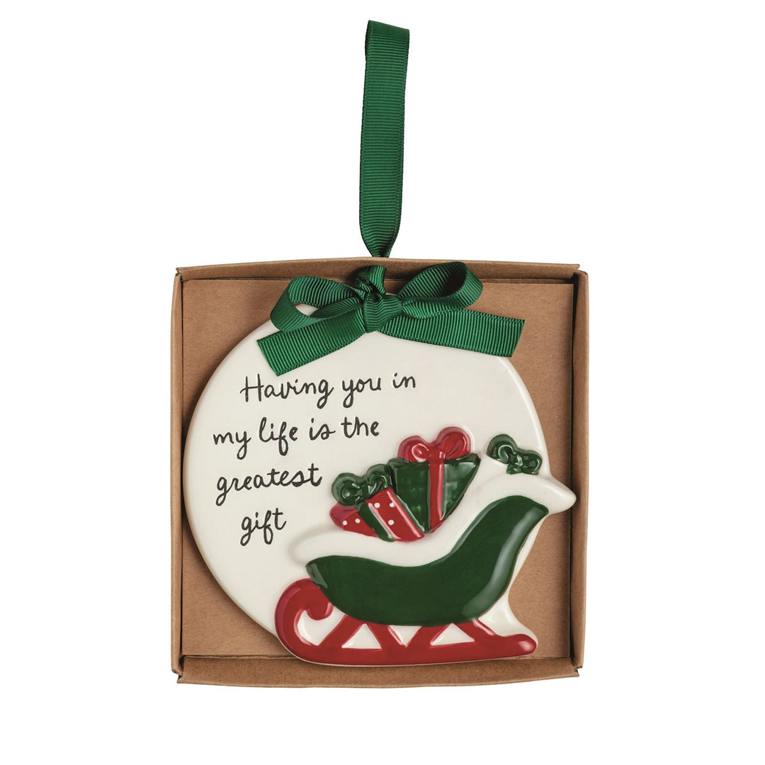 Round, hand-painted ceramic Thank You Ornament featuring a gift-filled sleigh and the text “Having you in my life is the greatest gift,” with a green ribbon topper.