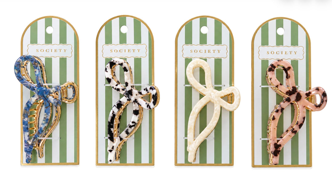 Set of four patterned Metal Bow Claw Clips in blue, black and white, cream, and pink tortoiseshell designs. Available in small and medium sizes.