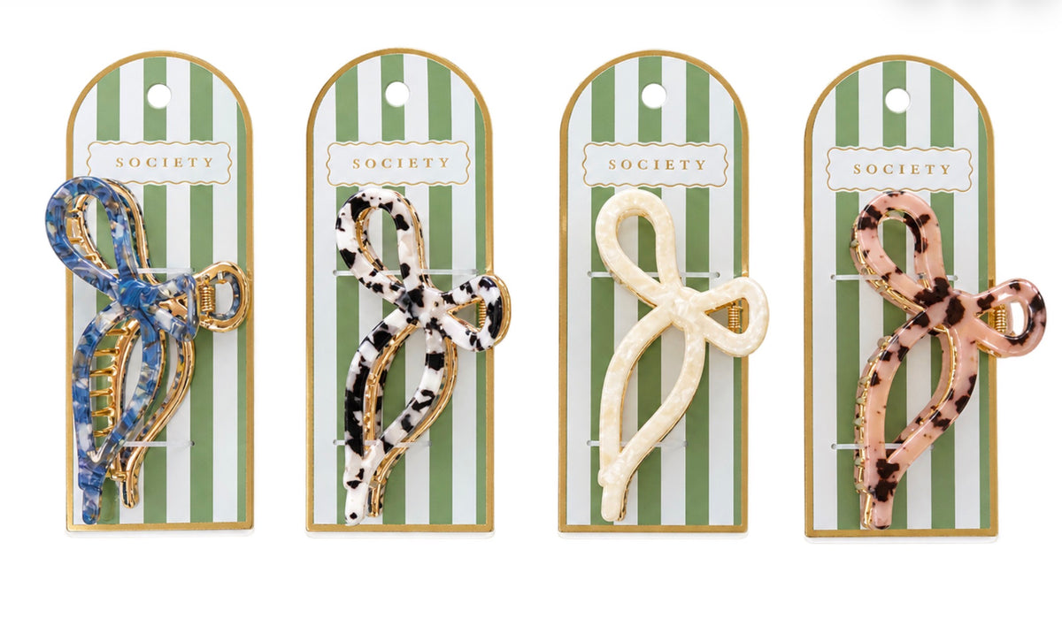 Set of four patterned Metal Bow Claw Clips in blue, black and white, cream, and pink tortoiseshell designs. Available in small and medium sizes.