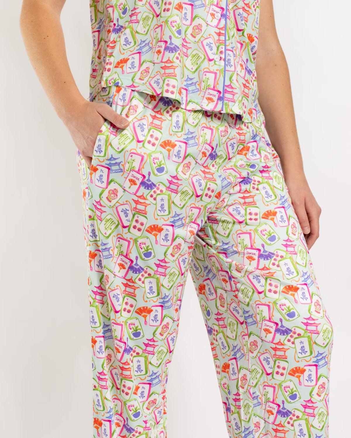 Mahjong Dreams Short Sleeve features a vibrant, colorful Mahjong tile pattern. Available in sizes S–XXL.