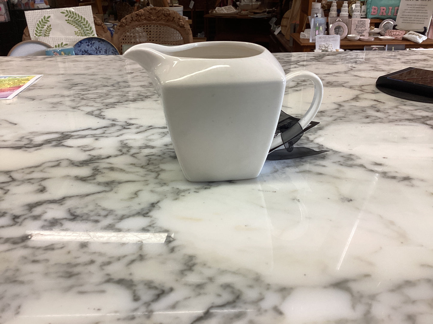 Small porcelain white creamer. Available sizes: small. Simple, smooth finish.